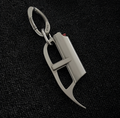 Metallic carabiner with a unique design on a black textured background