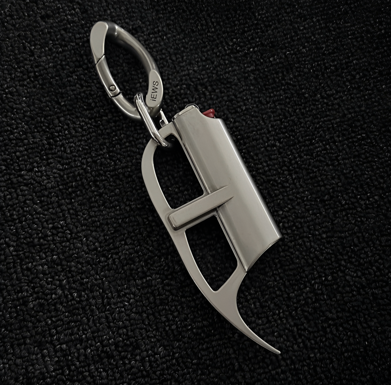 Metallic carabiner with a unique design on a black textured background
