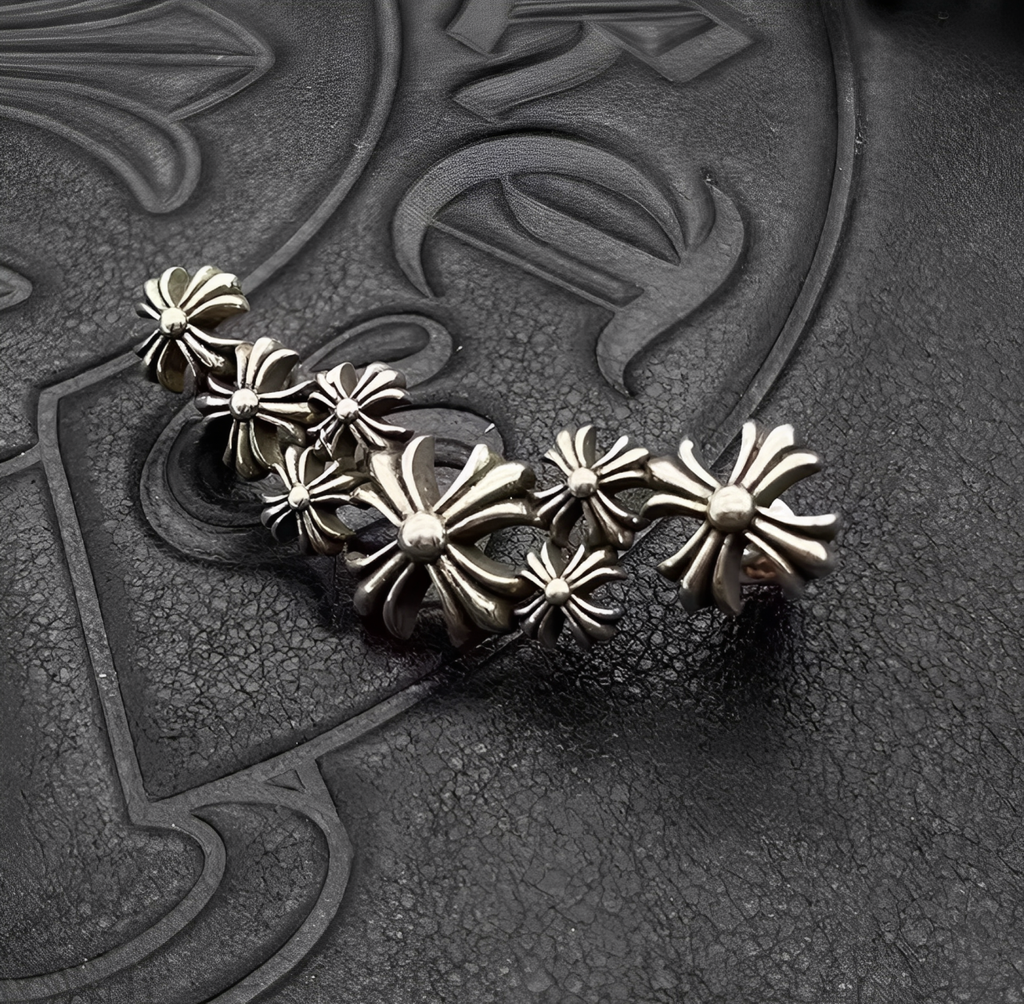 Silver floral brooch on a textured black background