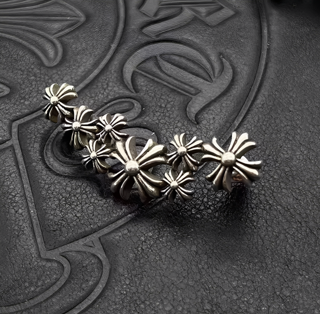 Silver floral brooch on a textured black background