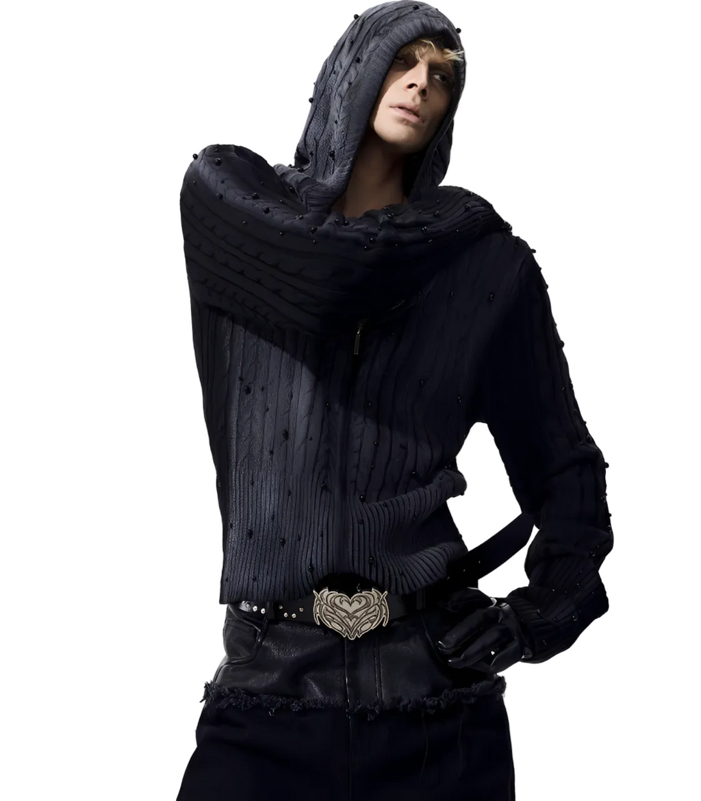 Person wearing a dark knit sweater and scarf with a white background